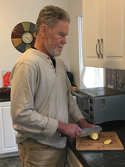 Chris Kuell slices a vegetable.