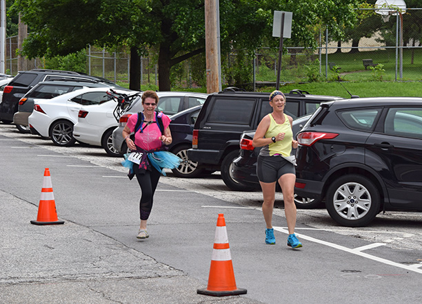 A sighted runner wearing a tutu participates in the 6 Dot Dash