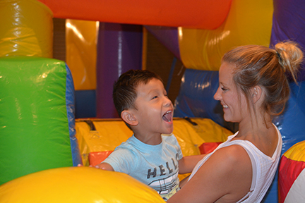 Four-year-old Theo Thevo of Michigan tumbles with his older sister in the bounce house