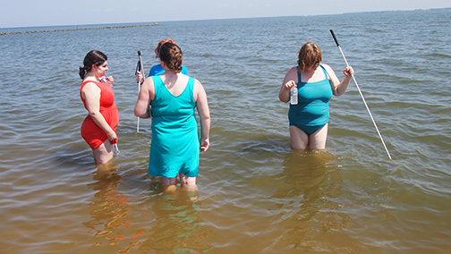 (Left to right) Karen Anderson, Rachel Olivero, Sophia Connell (behind Rachel), and Amy Mason enjoy the water at Sandy Point State Park.]