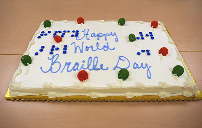 The sheet cake not only has the words “Happy World Braille Day” written in cursive in icing, but small candies spell out the same words in Braille.