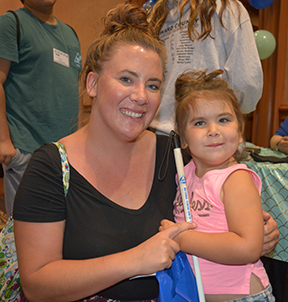 Sienna and daughter, Mercedes, smile for the camera while enjoying the Braille Carnival.
