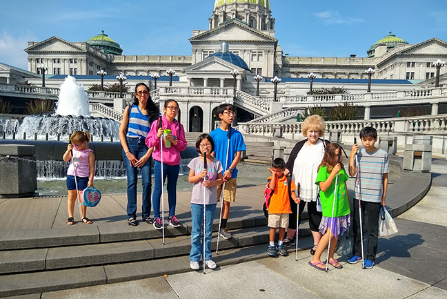 Participants in the Pennsylvania BELL program pose in front of the state capitol building.