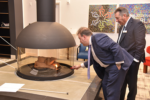 President Mark Riccobono lights the fireplace