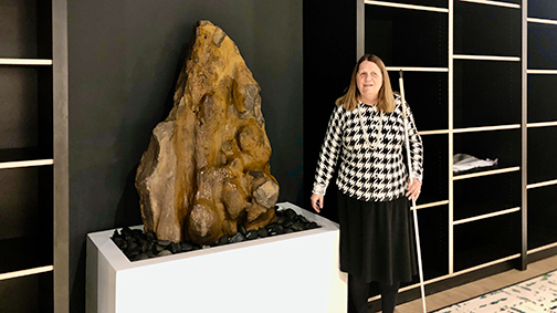 Julie Deden standing next to the fountain