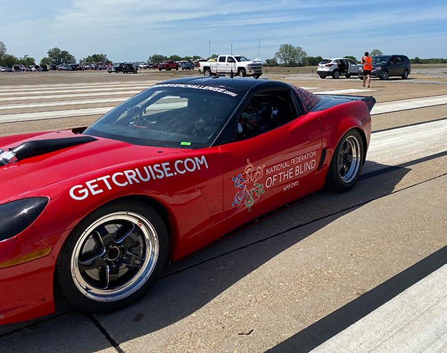 Dan Parker sits in the driver’s side of a corvette ready to make a race pass.