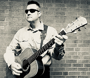 Tom Page playing his guitar.