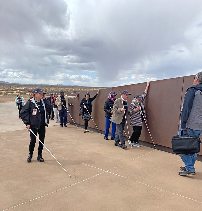 Leaders follow the metal wall that continues to rise as they get closer to the Gateway to Space building.