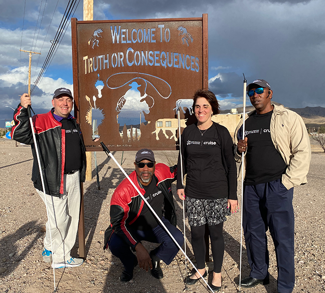 President Riccobono, Anil Lewis, Pam and Roland Allen pose for a picture at the Welcome to Truth or Consequences town sign.