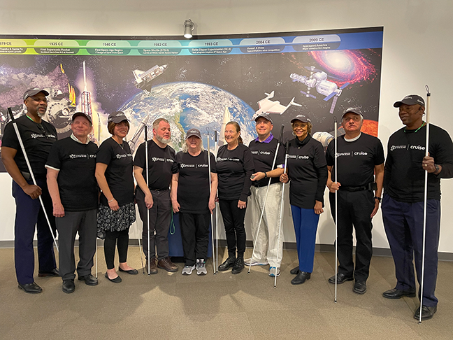 Anil Lewis, Glenn Crosby, Pam Allen, Chris Danielsen, Norma Crosby, Carla McQuillan, President Mark Riccobono, Ever Lee Hairston, Adelmo Vigil, and Roland Allen pose for a picture together inside Spaceport.