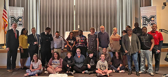 Multiple staff members and students from Mississippi and Oklahoma pose with Mark Riccobono, Pam Allen, and LaShawna Fant in the Mississippi School for the Blind auditorium.