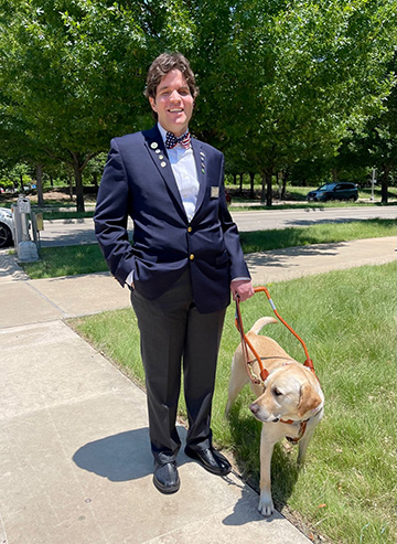 Ogulcan Kalkanli with his guide dog, Deputy