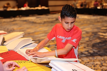The Braille Book Fair is always a popular event. Uriajah checks out a new book he is interested in.
