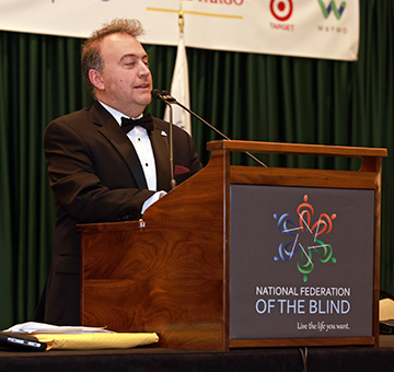 Mark Riccobono smiles as he speaks to the members at banquet.