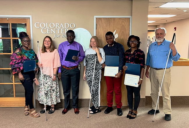 At the end of their two weeks with us, our Liberian guests each spoke to the assembled staff and students about their experience at CCB and what they will take back to their blind students. They also received certificates from Julie. Left to right are Nokutula Ncube, Julie Deden, Noah Z. Gibson, Maureen Nietfeld, Suahibu Paasewe, Miatta Kollie, and Dan Burke.