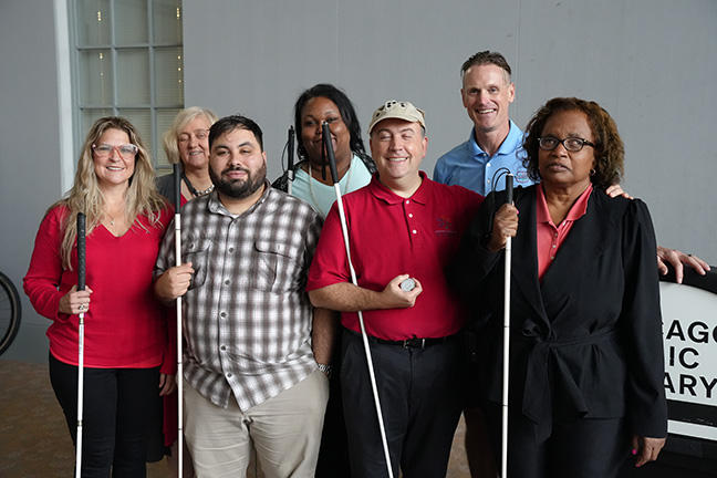 Mark Riccobono and Dan O&rsquo;Rourke pose with Chicago Chapter Ride for Literacy Committee, Michelle Ault, Patti Chang, Dustin Cather, Marilyn Green, and Denise Avant.