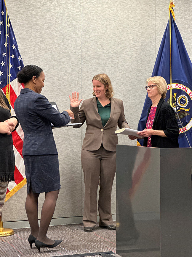 Charlotte Burrows, chair of the Equal Employment Opportunity Commission, administers Karla&rsquo;s oath of office. Karla&rsquo;s hand rests on a Braille copy of the Constitution her mother, Janet Gilbride, is holding.