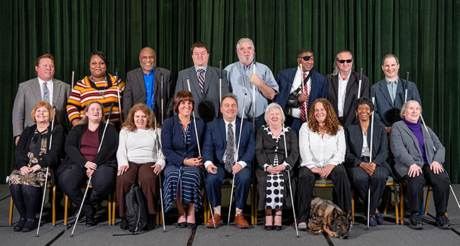The NFB Board of Directors: left to right, back row: Everette Bacon, Marilyn Green, Shawn Callaway, Ben Dallin, Jim Marks, Donald Porterfield, Tom Page, Tracy Soforenko; front row: Shelia Wright, Jamie Richey, Grace Pires, Pam Allen, Mark Riccobono, Norma Crosby, Jessica Beecham, Barbara Manuel, Marci Carpenter