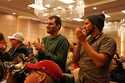 The packed room at the Great Gathering-In gave the speakers a standing ovation.