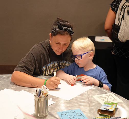 Mother and son, Mandy and Ryan, draw together in the Tactile Art Room.