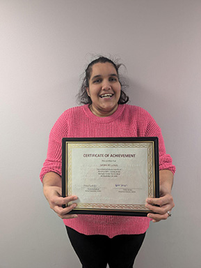 Sania Kellogg receives her graduation certificate for completing her blindness training.