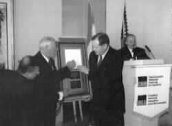 Euclid Herie is shown presenting a plaque to Ambassador Chtetien)