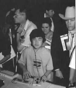 Photo of 
Tim Day with earphones on his head and his hands on the keyboards.