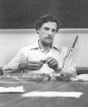 Dr. Vermeij examining shells with his hands.