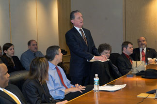 President Marc Maurer stands behind his chair with his Braille notes perched on its back. NFB First Lady Patricia Maurer sits to his left and U.S. Secretary of Education Arne Duncan sits to his right.