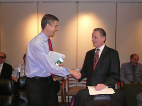 U.S. Secretary of Education Arne Duncan and NFB President Marc Maurer shake hands at the beginning of the book presentation ceremony.