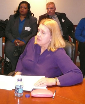 Dr. Denise Colton, a mother of two blind children, delivers remarks while seated at the U.S. secretary of education's conference table.