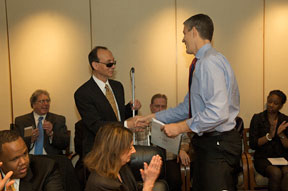 NFB First Vice President Fredric K. Schroeder presents the book to U.S. Secretary of Education Arne Duncan.