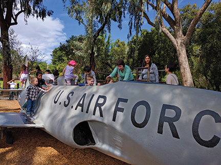 Ronit Mazzoni and her children explore the replica of a plane.