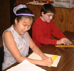 Amy Herstein and Gary Kammerer take notes at a transition club meeting.