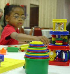 Alicia Jones of Kentucky looks at a display of Discovery Toys at the NFB National Convention.