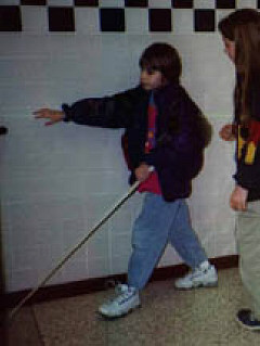 Cane in hand, Rachel hustles down the corridor to her next class.