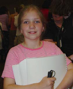 Lindsay Upschultze, a three-time winner from Illinois was one of the numerous winners and contest participants who came with their families to participate in the UPS-sponsored twentieth anniversary celebration of the Braille Readers Are Leaders Contest and first annual Braillw book flea market held at the NFB convention on Monday June 30, 2003/