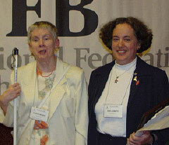 Sheila Amato accepts her award from Sharon Mineki, chairman of the 2003 Distinguished  Educator of Blind Children Award committee.
