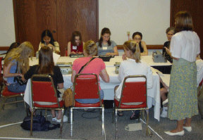 Twelve teens sit poised with notetakers, Braillewriters,and/or slates to begin the NOPBC-sponsored "I Want to be a Writer" workshop.  Conducted by three blind women -Bebbie Kent Stein, a successful author of books for youth; Sheila Koenig, a middle school English teacher; and Robin House, a high school counselor - the workshop had a dual purpose: to introduce teens to writing techniques and strategies used by professional writers, and to give them an opportunity to interact with accomplished blind role models.