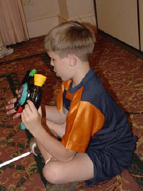 Blind youngster, Nick Pavel of South Dakota, tests his skills on BopIt during an NFB Camp session.