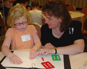 Melody Lindsey and Meghan Palmer playing a Braille game