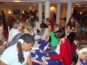 Children and adults line up at the flea market display tables eager for the rare pleasure of browsing through stacks and stacks of "gently used" Braille bools.
