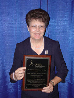 Jan Zollinger poses with her award