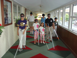 Many families participate in the annual Cane Walk. Here, the Patrick family (Alabama) �step out� with canes and sleepshades during a Cane Walk at the Louisville Galt House hotel.