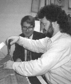 Photo of Rodger Dooley and his former instructor, Donald Mitchel, working on a piano at the Emil Fries Piano Hospital & Training Center