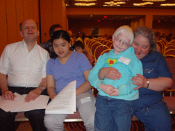 The Jacobson family (from left to right, Steve, Elizabeth, Nadine, and Catherine) arrives early to get good seats at a Federation meeting where Elizabeth is scheduled to speak.