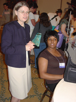 NOPBC president, Barbara Cheadle (left), and Maryland parent, Sharanda Baker, accept donations from grateful book lovers.
