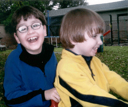Vejas and Petras Vasiliauskas playing on the lawn of their California home. Blindness is no big deal to them. 