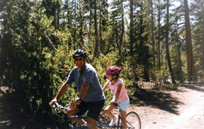 Kyra (age 11) and Dad enjoy a ride on the tandem mountain bike. 