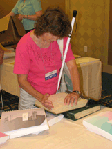 Here, Linda Anderson (Colorado) reads through a few titles before taking her picks to the volunteers to be shipped home.